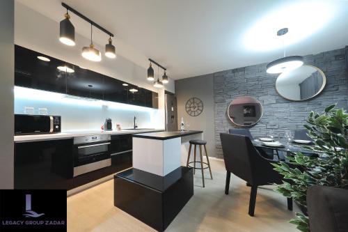 a kitchen with a bar and a dining room at Legacy Marine2 - Zadar, Luxury Suites in Zadar
