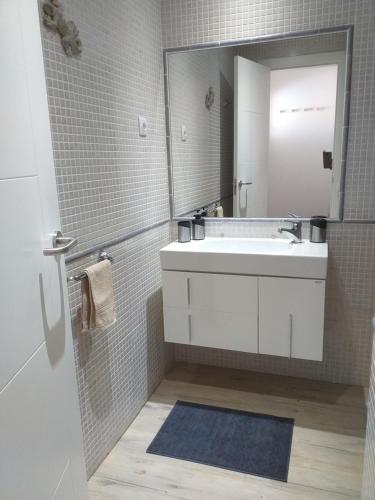 a bathroom with a white sink and a mirror at Casa Kristin (WLAN gratis) in Costa Calma