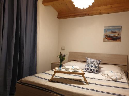 a bedroom with a bed with a table on it at Villa Oneiro Fronte Mare in Santa Maria Del Focallo