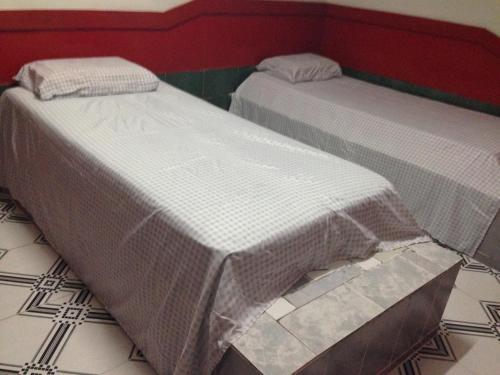 two beds sitting next to each other in a room at Hotel Spada in Belém