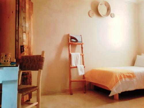 a bedroom with a bed and a ladder next to a bed at Dakhla Ride Adventures in Dakhla