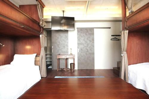 a bedroom with a bed and a table in a room at Creare Ryogoku in Tokyo