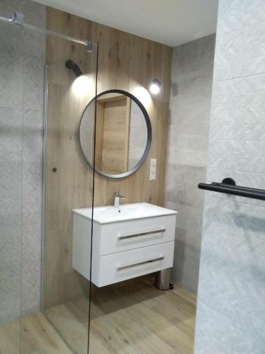 a bathroom with a white sink and a mirror at Bratkowa Dolina in Szczyrk