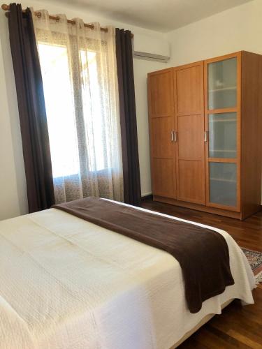 a bedroom with a bed and a dresser and a window at B&B Roomantic & Piscina Idromassaggio in Cefalù