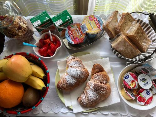 a table topped with bread and fruits and other foods at B&B Roomantic & Piscina Idromassaggio in Cefalù
