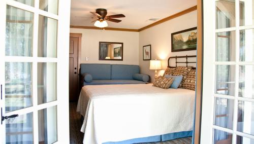 a bedroom with a bed and a ceiling fan at Sierra Sky Ranch in Oakhurst