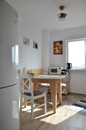a kitchen with a table and chairs in a room at Belvedere Studio in Tulcea