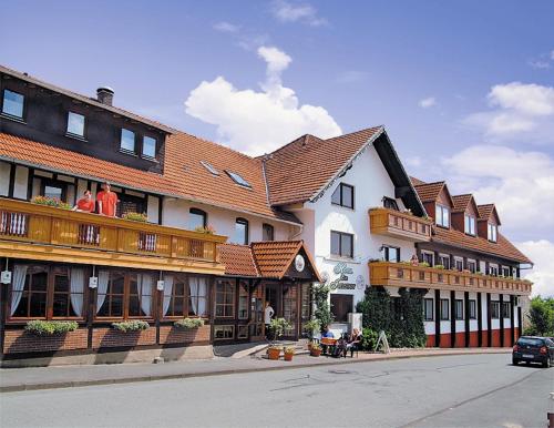 a large building with people sitting on a balcony at Hotel Igelstadt in Fürstenberg
