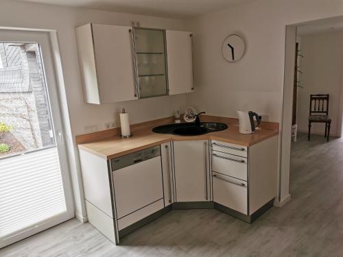 a kitchen with a sink and a counter top at Traumhafte Ferienwohnung in zentraler Lage in Bad Berleburg