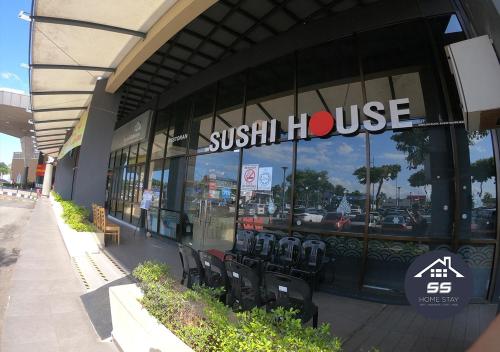 a sushi house with chairs in front of a building at KULAI HOME STAY @IOI MALL/JPO/AEON/SENAI AIRPORT in Kulai