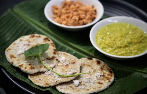 a plate of food with bread and a bowl of dip at Bay Vista in Arugam Bay