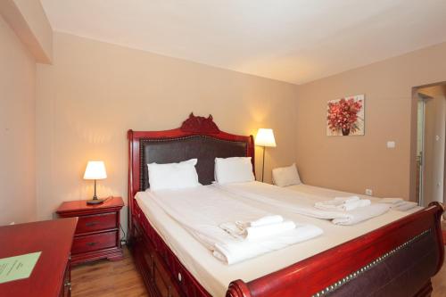 a bedroom with a large bed with towels on it at Hotel Panorama in Panichishte