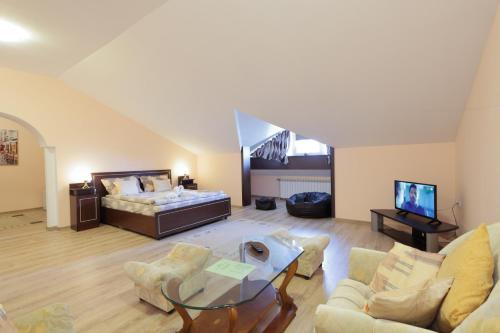 a living room with a bed and a couch at Hotel Panorama in Panichishte