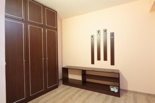 a room with wooden cabinets and a bench on the wall at Hotel Panorama in Panichishte
