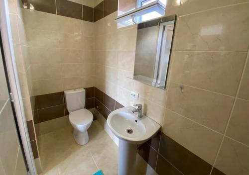 a small bathroom with a toilet and a sink at Катюша морская in Zatoka