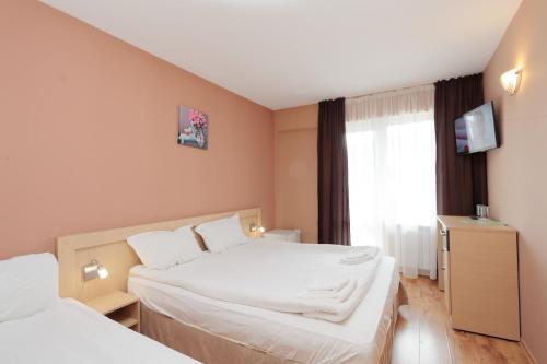 a hotel room with two beds and a window at Hotel Panorama in Panichishte