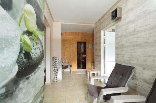 a living room with a chair and a wall at Hotel Panorama in Panichishte