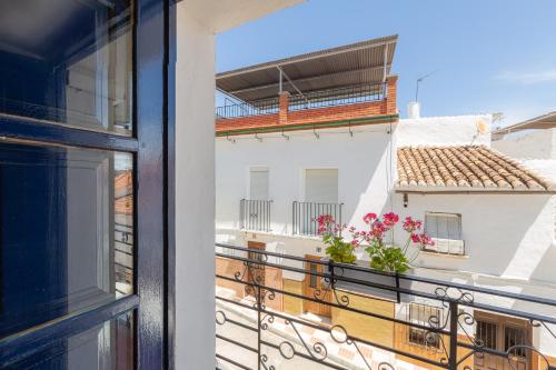 a balcony with a view of a building at Casa Randonneur, traditional townhouse in Álora. in Alora