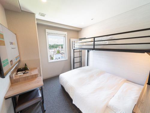 a bedroom with a bunk bed and a desk at Super Hotel Higashi-Maizuru in Maizuru