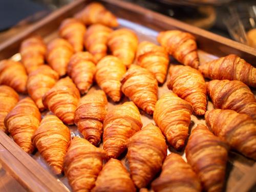 a bunch of croissants sitting in a display case at Super Hotel Higashi-Maizuru in Maizuru