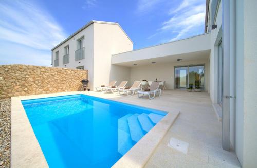 a swimming pool in the backyard of a house at Villa Terra in Županje