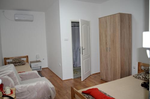 a living room with two beds and a closet at Rooms Maša in Palić