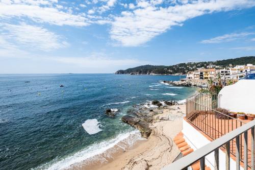a view of the ocean from a balcony at Casa Concha Apartamentos in Calella de Palafrugell