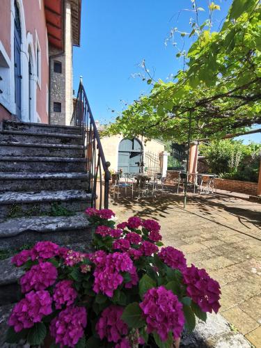 a bunch of purple flowers in front of a building at Hotel Pescille Country House - Tuscany Charme in San Gimignano