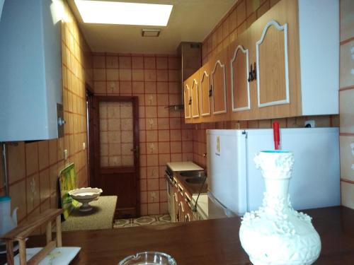 une cuisine avec un vase blanc assis sur une table dans l'établissement El Carmen, à Cazalla de la Sierra