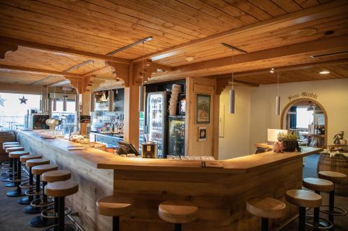 a kitchen filled with wooden cabinets and wooden tables at Berggasthaus First in Grindelwald