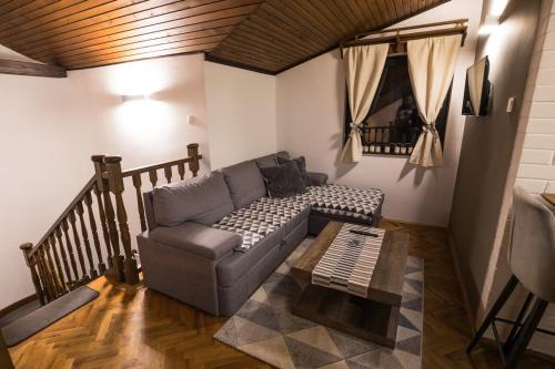 a living room with a couch and a coffee table at Holiday House Belajec in Popovača