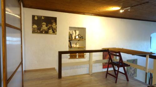 a room with a wooden desk and a chair at The old olive mill house in Aegae