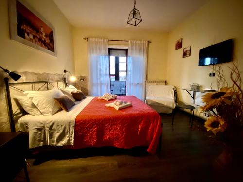 a bedroom with a bed with a red blanket at Sweet Rome B&B in Rome