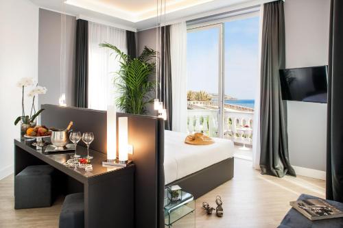 a hotel room with a bed and a large window at Sanremo Luxury Suites in Sanremo