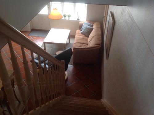 a person sitting on a couch in a living room at Tversted Apartment in Tversted