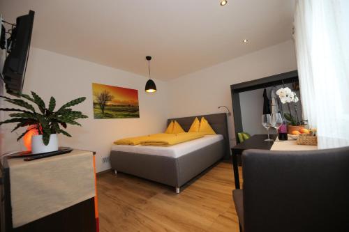 a bedroom with a bed with yellow pillows and a table at Appartement Ilvy in Söll