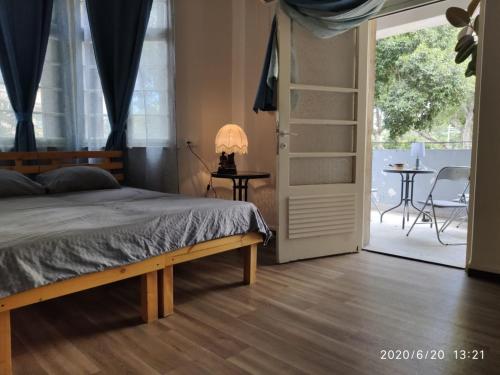 a bedroom with a bed and a sliding glass door at huge apartment near to Bahai Garden in Haifa