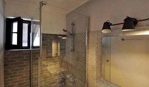 a bathroom with a shower with a glass door at Black Valley House in Gura Humorului