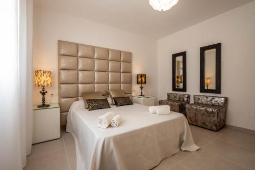a bedroom with a large bed with two towels on it at Can Garchet White Ibiza in Sant Jordi