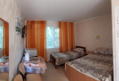a room with a bedroom with a bed and a couch at Зюйд in Gribovka