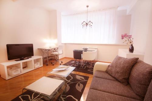 a living room with a couch and a tv at Apartments Belgrade in Belgrade