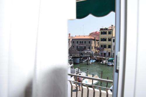 a view of a marina from a window at el Capitan de Mar in Chioggia