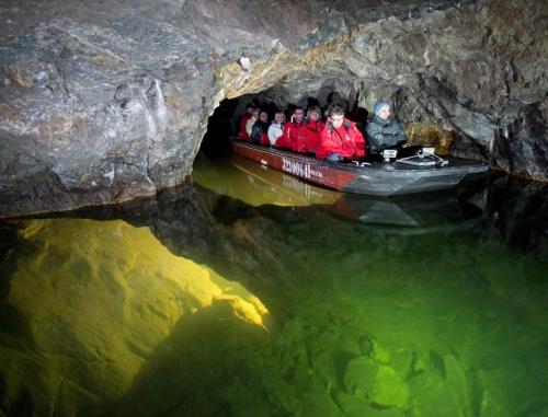 a group of people in a boat in a cave at Apartman Discoveryou in Rájec-Jestřebí