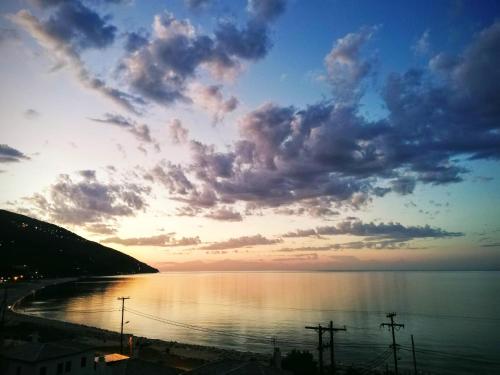 a sunset over a body of water with clouds at Hotel Erato in Chorefto