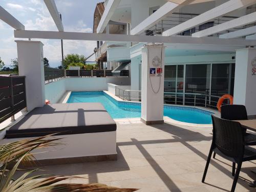 a swimming pool in the middle of a building at Crystal Aura in Paralia Katerinis