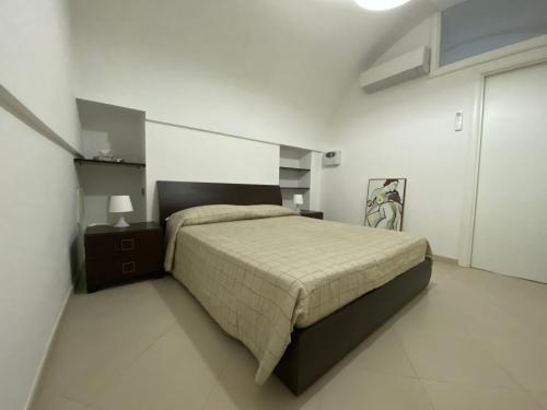 um quarto com uma cama grande num quarto branco em La casetta em Noci