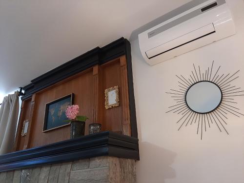 a room with a ceiling fan and a mirror at Petra Rooms and Apartments in Rab