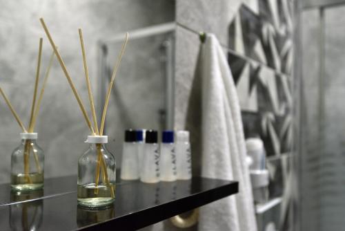 a black shelf with two bottles and a towel at Rays Otel in Istanbul