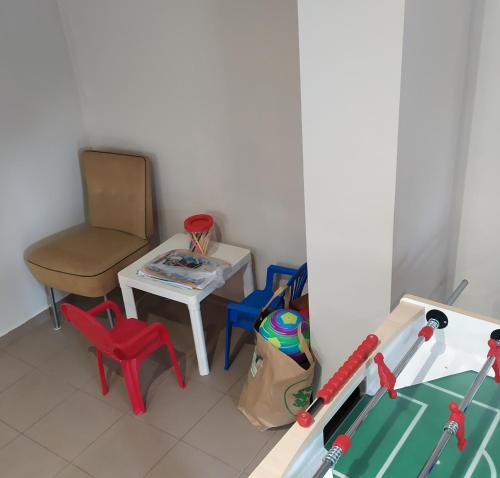 a living room with a chair and a table and a chair at Szilvia Panzió Gyomaendrőd in Gyomaendrőd