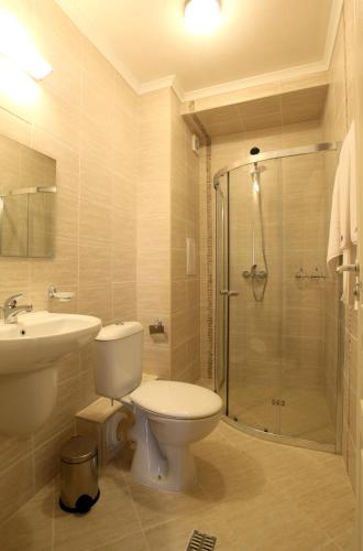 a bathroom with a toilet and a sink and a shower at MESSEMBRIA RESORT in Sunny Beach